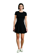 Woman wearing a black dress on a green background