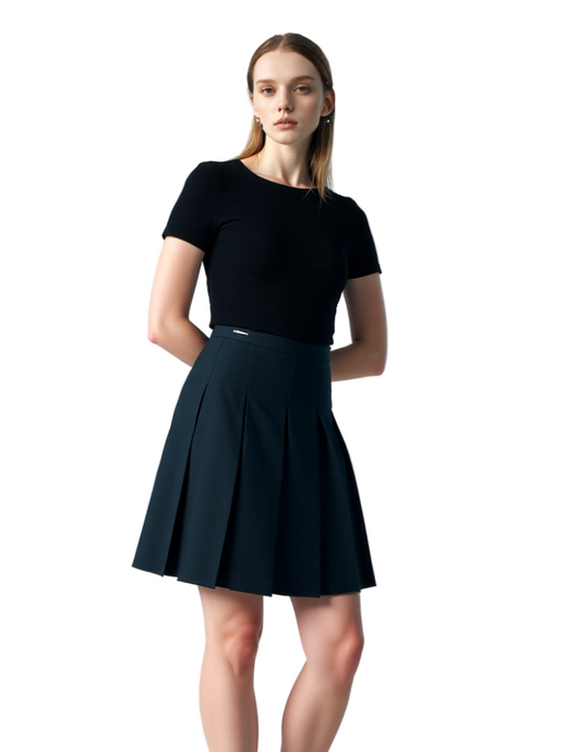 Woman wearing a black top and black skirt on a white background