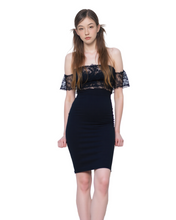 Woman wearing a black off-shoulder dress on a white background