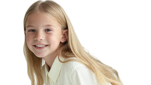 Young girl wearing a white shirt with text and a black skirt on a light gray background