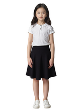 Young girl wearing a white polo shirt and black skirt on a white background